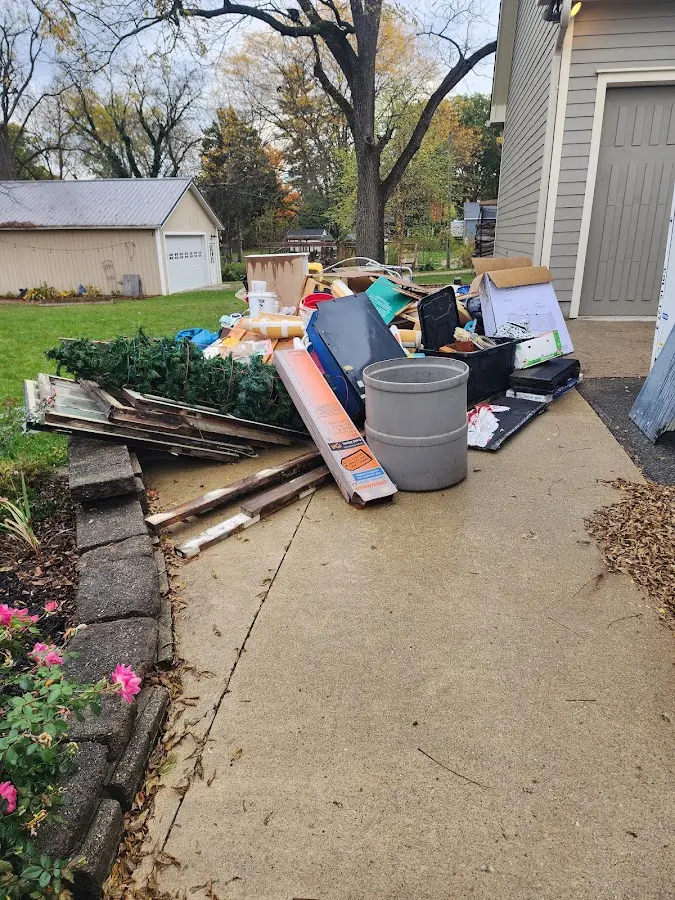 Dumpster being loaded with debris for 10 Yard Dumpster Rental in Ashburn